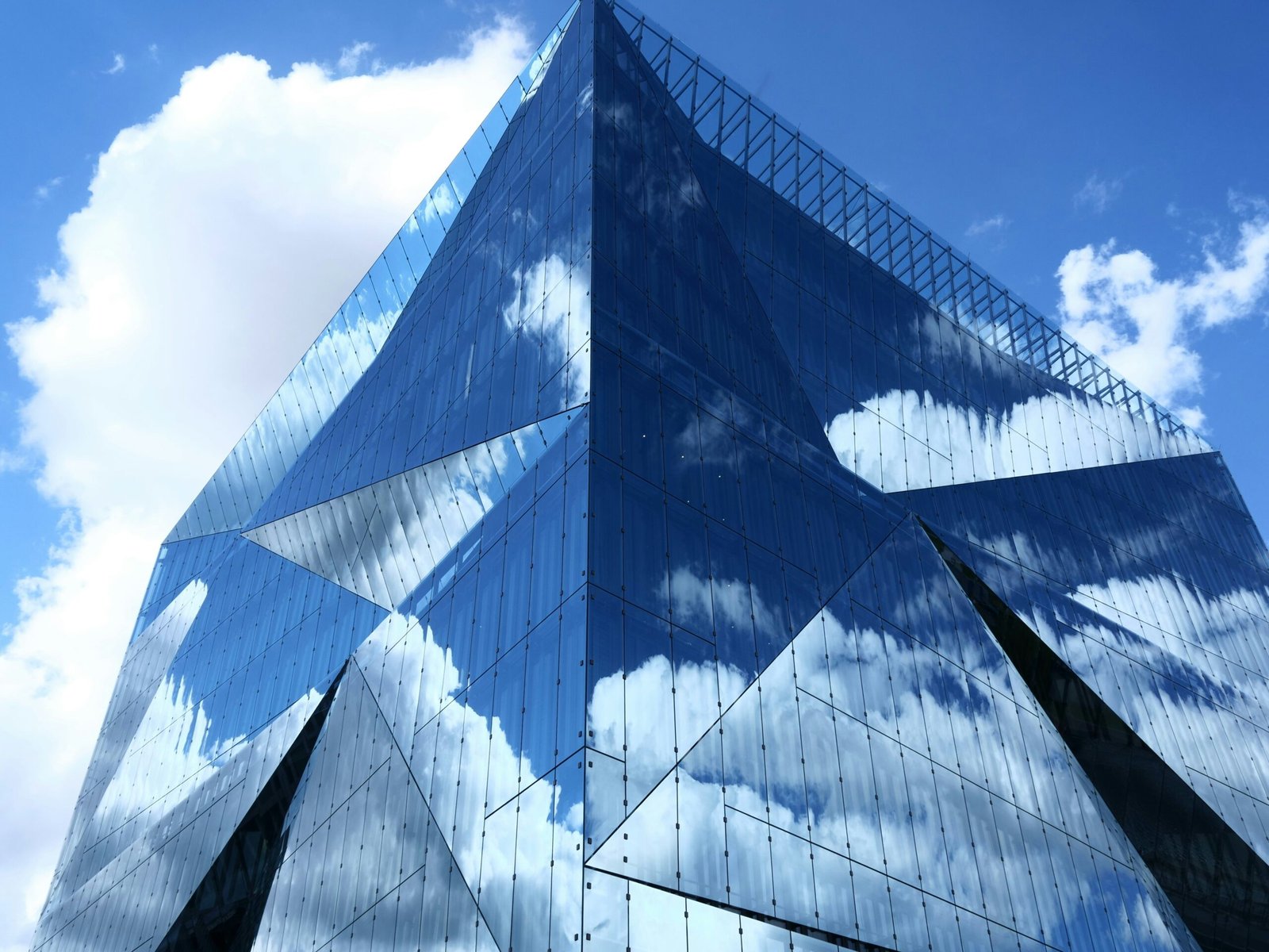 blue and white glass building under blue sky during daytime